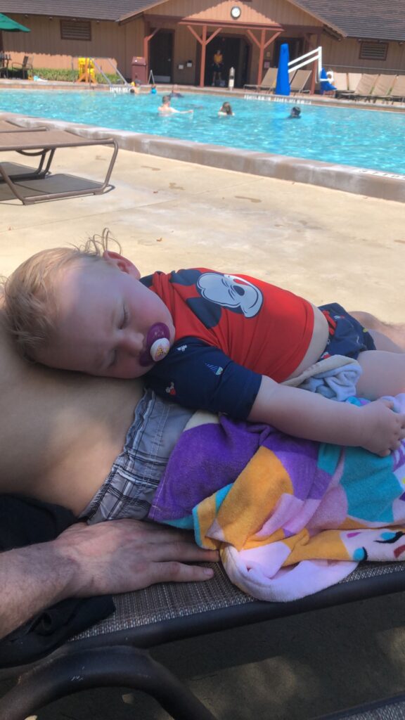 baby lounging at the pool at Fort Wilderness Campgrounds. 